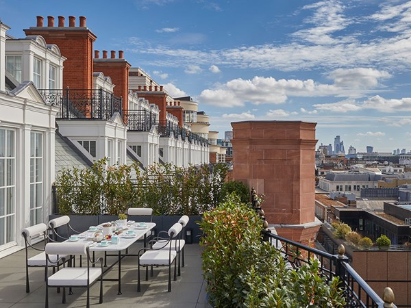 Grand Terrace Suite on a bright, blue sunny day with a breakfast spread set out on a table on the terrace